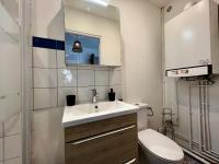 a bathroom with a sink and a toilet at Home Sweet Home in Roanne