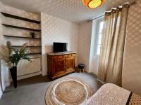 a living room with a tv and a window at Home Sweet Home in Roanne