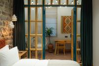 a bedroom with a bed and a room with a table at Khedi Hotel Tbilisi in Tbilisi City