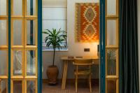 a dining room with a table and a potted plant at Khedi Hotel Tbilisi in Tbilisi City