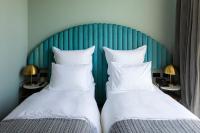 two beds sitting next to each other in a room at Khedi Hotel Tbilisi in Tbilisi City