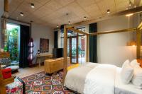 a bedroom with a bed and a desk and a television at Khedi Hotel Tbilisi in Tbilisi City