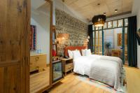 a bedroom with a white bed and a large window at Khedi Hotel Tbilisi in Tbilisi City