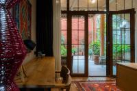 a living room with a door open to a patio at Khedi Hotel Tbilisi in Tbilisi City