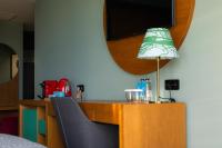 a room with a desk with a lamp and a tv at Khedi Hotel Tbilisi in Tbilisi City