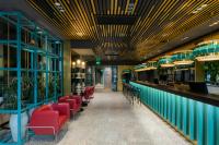 a dining room with red chairs and a bar at Khedi Hotel Tbilisi in Tbilisi City