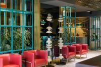 a waiting room with red chairs and blue windows at Khedi Hotel Tbilisi in Tbilisi City