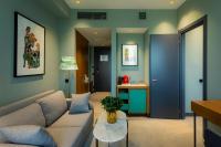a living room with a couch and a table at Khedi Hotel Tbilisi in Tbilisi City