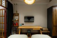 a room with a wooden table and a tv on the wall at Khedi Hotel Tbilisi in Tbilisi City
