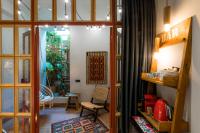 a room with a door and a chair and a table at Khedi Hotel Tbilisi in Tbilisi City