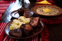 a table with two plates of food on a table at Casa Domnească Rarau in Câmpulung Moldovenesc