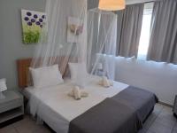A bed or beds in a room at Kardamena Holiday Apartments