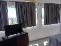 A television and/or entertainment centre at Kardamena Holiday Apartments