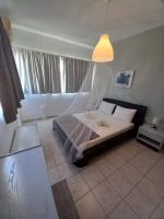 A bed or beds in a room at Kardamena Holiday Apartments