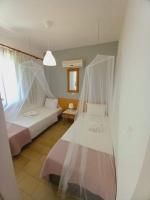 A bed or beds in a room at Kardamena Holiday Apartments