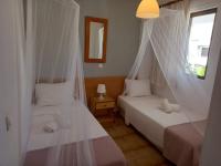 A bed or beds in a room at Kardamena Holiday Apartments