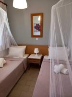 A bed or beds in a room at Kardamena Holiday Apartments