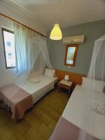 A bed or beds in a room at Kardamena Holiday Apartments