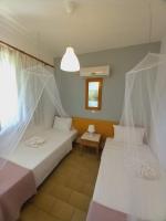 A bed or beds in a room at Kardamena Holiday Apartments