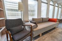 a living room with a couch and two chairs at Cloud Sun Homestay in Zhixue