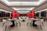 a restaurant with tables and chairs and red walls at Yangon Thanlwin Hotel in Yangon