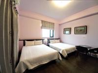 a hotel room with two beds and a window at Dreamily Fish B&amp;B in Magong