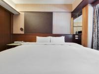 a large white bed in a hotel room at CHECK inn Express Taichung Fengchia in Taichung