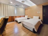a hotel room with two beds and a desk at CHECK inn Express Taichung Fengchia in Taichung