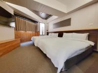 a large bedroom with a large bed and a television at CHECK inn Express Taichung Fengchia in Taichung