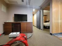 a room with a television and a room with a bed at CHECK inn Express Taichung Fengchia in Taichung