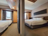 a hotel room with two beds and a television at CHECK inn Express Taichung Fengchia in Taichung