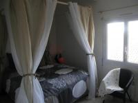 Tempat tidur dalam kamar di KIKINE