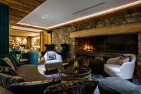 a living room with couches and a fireplace at Hôtel La Sivolière in Courchevel
