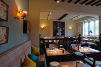 een restaurant met tafels en stoelen in een kamer bij Crown and Castle in Orford