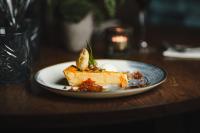 een stuk voedsel op een bord op een tafel bij Maplewood Cottage, Wynyard Hall in Grindon