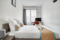 a bedroom with a large white bed and a desk at Cozy - Free Parking - 15mn from Paris Montparnasse in Clamart