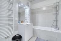 a white bathroom with a sink and a bath tub at Cozy - Free Parking - 15mn from Paris Montparnasse in Clamart