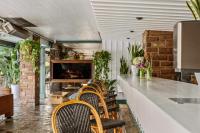 a bar with chairs and a counter in a restaurant at The Hollywood Roosevelt in Los Angeles