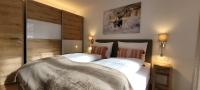 A bed or beds in a room at Hochalmbahnen Chalets Rauris 1-20 WE1, Maislaufeldweg 1r EG