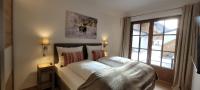 A bed or beds in a room at Hochalmbahnen Chalets Rauris 1-20 WE1, Maislaufeldweg 1r EG
