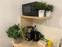 a kitchen counter with a coffee maker and potted plants at Studio entièrement refait a neuf - 170 in Rouen