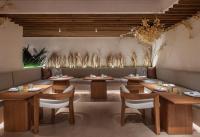 a dining room with wooden tables and chairs at Mondrian Los Angeles in Los Angeles