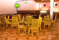 a dining room with tables and chairs and a television at ROYAL ACACIA HOTEL ISIOLO in Tarbaj