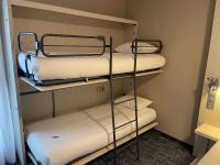 a room with three bunk beds in a room at ibis Styles Nivelles in Nivelles