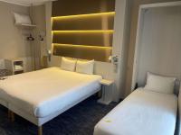 two beds in a hotel room with two at ibis Styles Nivelles in Nivelles