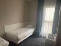 a small bedroom with a bed and a window at ibis Styles Nivelles in Nivelles