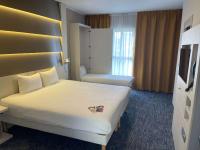 a hotel room with two beds with a heart on it at ibis Styles Nivelles in Nivelles