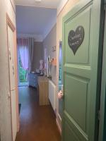 a hallway with a door with a heart sign on it at Le Moulin du Modon in Couffy