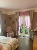a bedroom with a bed and a window with a chair at Le Moulin du Modon in Couffy
