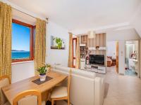 a dining room and living room with a table and chairs at Villa Ana Apartments in Mlini